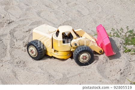 Dump truck toy working on the sand 92805519