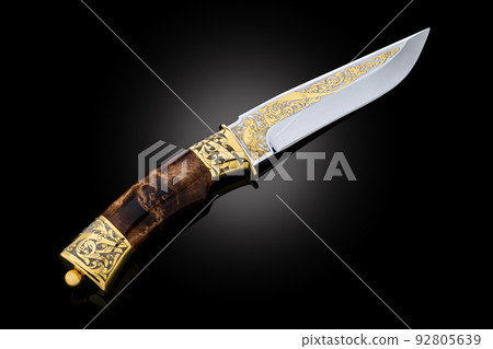 souvenir collectible silver gold dagger cutlass with scabbard, with metal engraving, on black background. Luxury weapons with traditional patterns in medieval vintage style. souvenir collectible silver gold dagger cutlass with scabbard, with metal engraving, on black background. Luxury weapons with traditional patterns in medieval vintage style. 92805639