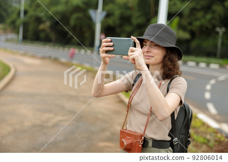 Smiling pretty woman making photo during the journey in Africa Smiling pretty woman making photo during the journey in Africa 92806014