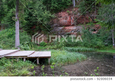 Mirror cliffs and an old river channel in a very beautiful forest in Cirulu nature trails, Latvia. 92806034