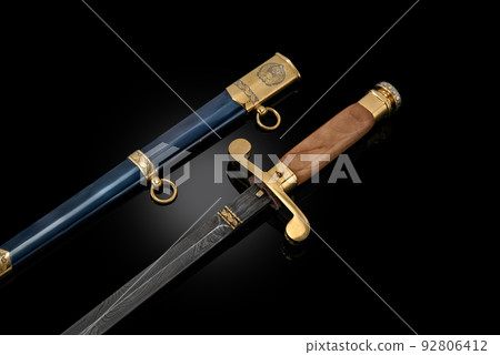 souvenir collectible silver gold dagger cutlass with scabbard, with metal engraving, on black background. Luxury weapons with traditional patterns in medieval vintage style. souvenir collectible silver gold dagger cutlass with scabbard, with metal engraving, on black background. Luxury weapons with traditional patterns in medieval vintage style. 92806412