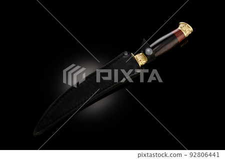 souvenir collectible silver gold dagger cutlass with scabbard, with metal engraving, on black background. Luxury weapons with traditional patterns in medieval vintage style. souvenir collectible silver gold dagger cutlass with scabbard, with metal engraving, on black background. Luxury weapons with traditional patterns in medieval vintage style. 92806441