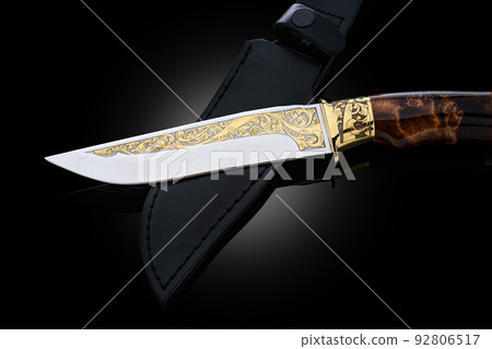 souvenir collectible silver gold dagger cutlass with scabbard, with metal engraving, on black background. Luxury weapons with traditional patterns in medieval vintage style. souvenir collectible silver gold dagger cutlass with scabbard, with metal engraving, on black background. Luxury weapons with traditional patterns in medieval vintage style. 92806517
