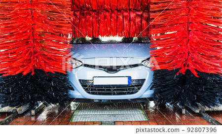 Automatic car wash. Auto brush washer clean blue car on automatic carwash station. Automatic car wash cleaning service. 92807396