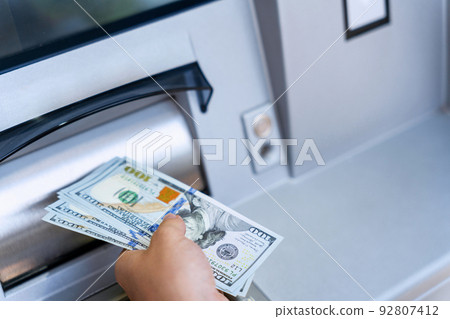 Atm money cash machine. Woman withdraw money bill. Holding american hundred dollar cash. Bank credit card, us dollar. Atm money cash machine. Woman withdraw money bill. Holding american hundred dollar cash. Bank credit card, us dollar. 92807412