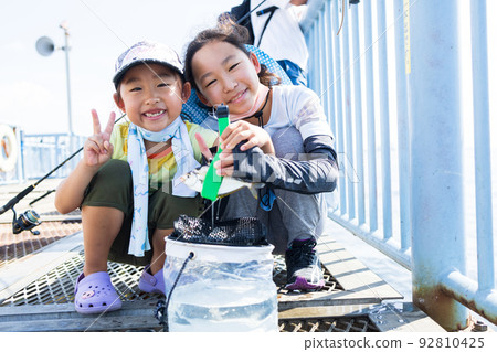 Girl enjoying fishing 92810425