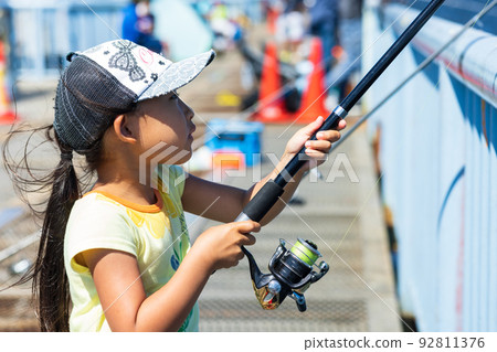 Girl enjoying fishing 92811376