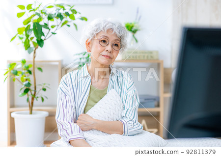 Senior woman watching TV with a smile 92811379