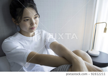 Young woman dazed in bedroom 92812211