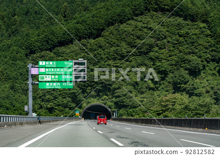 A car approaching the Fujikawa Tunnel on the Shin-Tomei Expressway, Shizuoka Prefecture 92812582