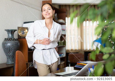 Young attractive woman in white blouse undress at office 92813005