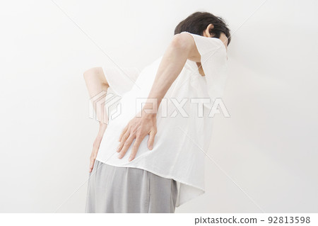 Back view of a senior woman with back pain White background Back view of a senior woman with back pain White background 92813598