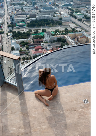 Anonymous seductive woman at poolside on roof Anonymous seductive woman at poolside on roof 92814740