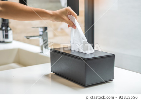 hand pulling toilet paper in bathroom. Cleaning, Lifestyle and personal hygiene concept 92815556