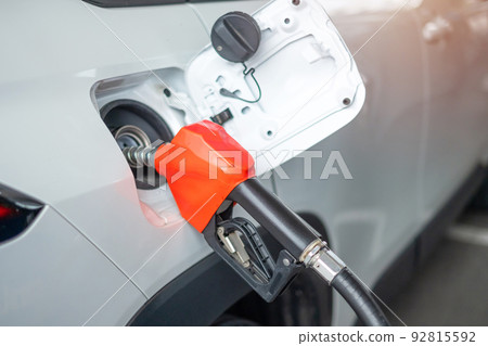 Man hand refuel to car, gasoline fuel nozzle in vehicle at petrol station. Oil Price, petroleum economy, inflation and commodity concept 92815592
