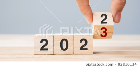 hand flip cube block 2022 to 2023 text on table. Resolution, review, strategy, end year, goal, business and New Year holiday concepts hand flip cube block 2022 to 2023 text on table. Resolution, review, strategy, end year, goal, business and New Year holiday concepts 92816134