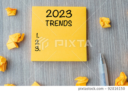 2023 Trends word on yellow note with pen and crumbled paper on wooden table background. New Year New Start, Resolutions, Strategy and Goal concept 2023 Trends word on yellow note with pen and crumbled paper on wooden table background. New Year New Start, Resolutions, Strategy and Goal concept 92816150