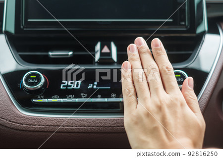 Woman hand checking the air flowing during driving car on the road, air conditioner cooling system inside the car. Adjust, temperature and transport concept Woman hand checking the air flowing during driving car on the road, air conditioner cooling system inside the car. Adjust, temperature and transport concept 92816250
