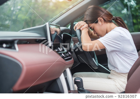 woman feeling stress and angry during drive car long time. Asian girl tired and fatigue having headache stop after driving car in traffic jam. Sleepy, stretching and drunk concept woman feeling stress and angry during drive car long time. Asian girl tired and fatigue having headache stop after driving car in traffic jam. Sleepy, stretching and drunk concept 92816307