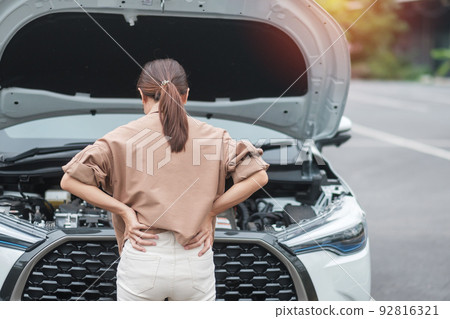 woman driver standing near a problem car. Breakdown or broken car on road. Vehicle Insurance, maintenance and service concept 92816321