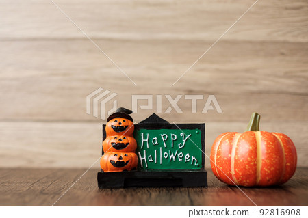 Orange pumpkin on table with copy space for banner background. Happy Halloween day, Hello October, fall autumn season, Festive, party and holiday concept Orange pumpkin on table with copy space for banner background. Happy Halloween day, Hello October, fall autumn season, Festive, party and holiday concept 92816908