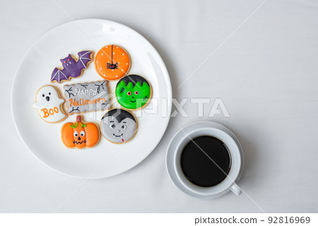 hot coffee cup with funny Halloween Cookies. Happy Halloween day, Trick or Threat, Hello October, fall autumn, Traditional, party and holiday concept hot coffee cup with funny Halloween Cookies. Happy Halloween day, Trick or Threat, Hello October, fall autumn, Traditional, party and holiday concept 92816969