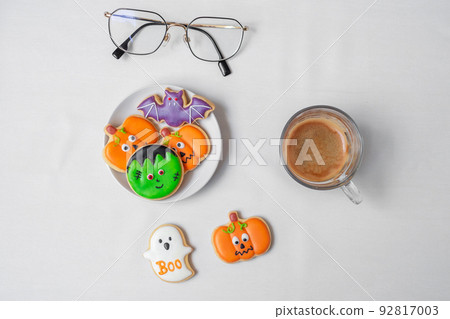 hot espresso coffee or chocolate cup with funny Halloween Cookies. Happy Halloween day, Trick or Threat, Hello October, fall autumn, Traditional, party and holiday concept hot espresso coffee or chocolate cup with funny Halloween Cookies. Happy Halloween day, Trick or Threat, Hello October, fall autumn, Traditional, party and holiday concept 92817003