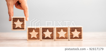 Man hand holding Star block. Customer choose rating for user reviews. Service rating, ranking, customer review, satisfaction, evaluation and feedback concept Man hand holding Star block. Customer choose rating for user reviews. Service rating, ranking, customer review, satisfaction, evaluation and feedback concept 92817179