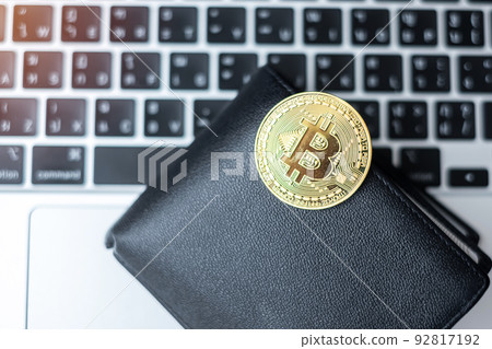 golden Cryptocurrency and wallet on keyboard laptop, Bitcoin coin. Crypto is Digital Money within the blockchain network golden Cryptocurrency and wallet on keyboard laptop, Bitcoin coin. Crypto is Digital Money within the blockchain network 92817192