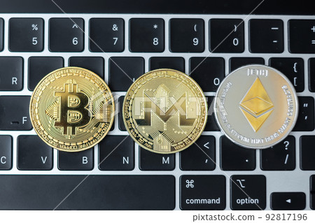 golden and silver Cryptocurrency on keyboard laptop, Bitcoin , Ethereum, Monero coins. Crypto is Digital Money within the blockchain network golden and silver Cryptocurrency on keyboard laptop, Bitcoin , Ethereum, Monero coins. Crypto is Digital Money within the blockchain network 92817196