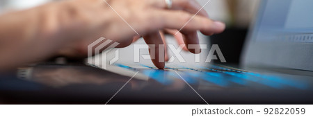 Female fingers typing glowing laptop computer 92822059