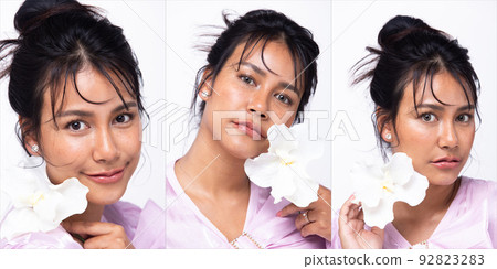 Asian Indian woman show beautiful smile happy lips, hold white flower as fresh clean skin care Asian Indian woman show beautiful smile happy lips, hold white flower as fresh clean skin care 92823283