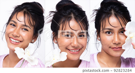 Asian Indian woman show beautiful smile happy lips, hold white flower as fresh clean skin care Asian Indian woman show beautiful smile happy lips, hold white flower as fresh clean skin care 92823284
