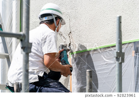 Construction site, exterior wall repair work, multi-tool 92823961