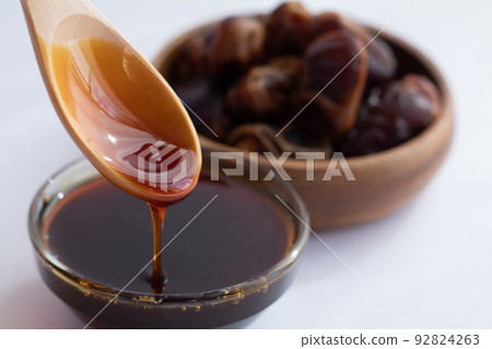 Image of scooping date syrup Image of scooping date syrup 92824263
