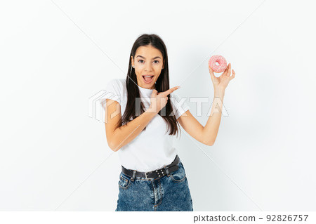 Surprised happy young woman wearing white t-shirt 92826757