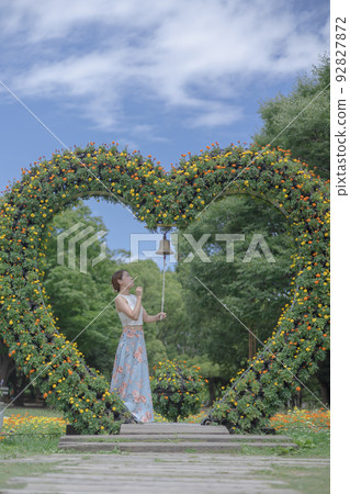 A woman standing with a heart-shaped object at Nagai Botanical Garden A woman standing with a heart-shaped object at Nagai Botanical Garden 92827872