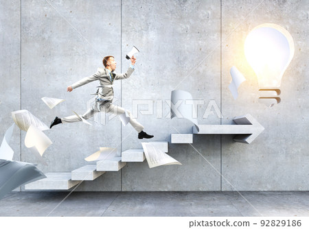 Portrait of energetic businessman jumping in open air Portrait of energetic businessman jumping in open air 92829186