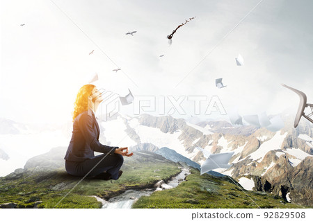 Beautiful businesswoman meditating . Mixed media Beautiful businesswoman meditating . Mixed media 92829508