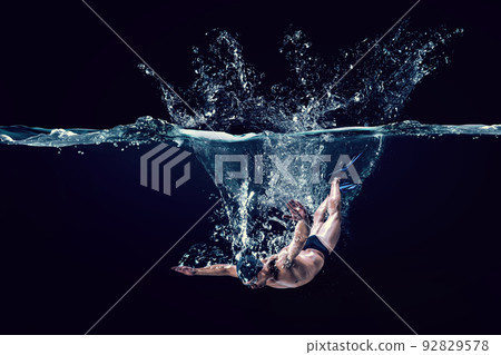 Professional man swimmer on a wave Professional man swimmer on a wave 92829578