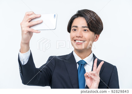 Young businessman taking a selfie Young businessman taking a selfie 92829843
