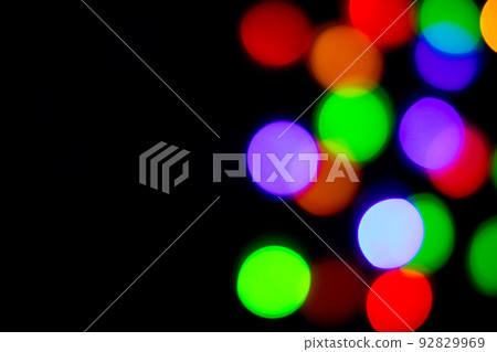 A brilliant glowing background side on black. The glitter light bokeh for the New Year and other holidays. A brilliant glowing background side on black. The glitter light bokeh for the New Year and other holidays. 92829969