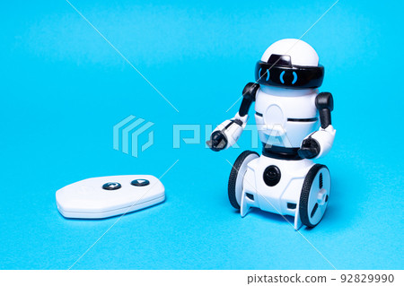 Robot on a blue background. A toy for a boy on the radio control with a remote control with a place for text for a toy store and children's technology centers. 92829990