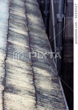 The faded and dirty roof of a 25-year-old detached house The faded and dirty roof of a 25-year-old detached house 92830327
