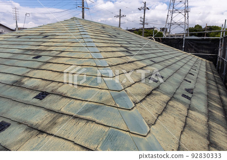 The faded and dirty roof of a 25-year-old detached house The faded and dirty roof of a 25-year-old detached house 92830333