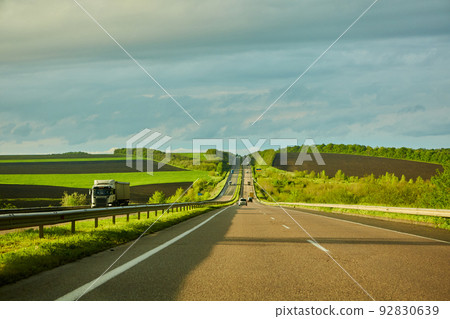 The highway traffic in sunset before the thunderstorm 92830639