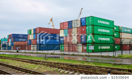 Odessa, Ukraine - May 19, 2021: Freight containers in the port terminal. Containers labeled Evergreen in the foreground. Odessa, Ukraine - May 19, 2021: Freight containers in the port terminal. Containers labeled Evergreen in the foreground. 92830694