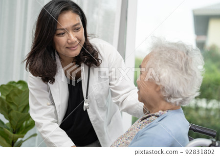 Help and care Asian senior or elderly old lady woman patient sitting on wheelchair at nursing hospital ward, healthy strong medical concept 92831802