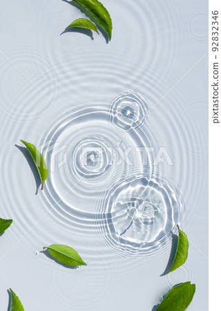Organic cosmetic background clean transparent waves, water splashes with green leaves Organic cosmetic background clean transparent waves, water splashes with green leaves 92832346