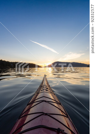 Sea Kayak paddling in the Pacific Ocean. Colorful Sunset Sky. Sea Kayak paddling in the Pacific Ocean. Colorful Sunset Sky. 92832577